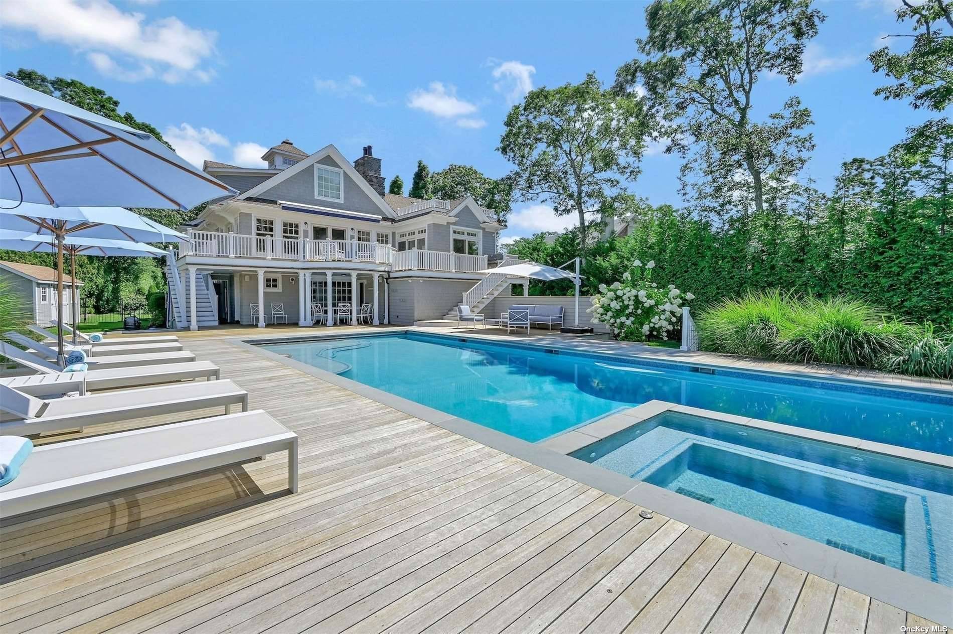 This custom built Nantucket style home is nestled at the end of a long gated driveway, offering unparalleled privacy and captivating western views over Quantuck Creek.