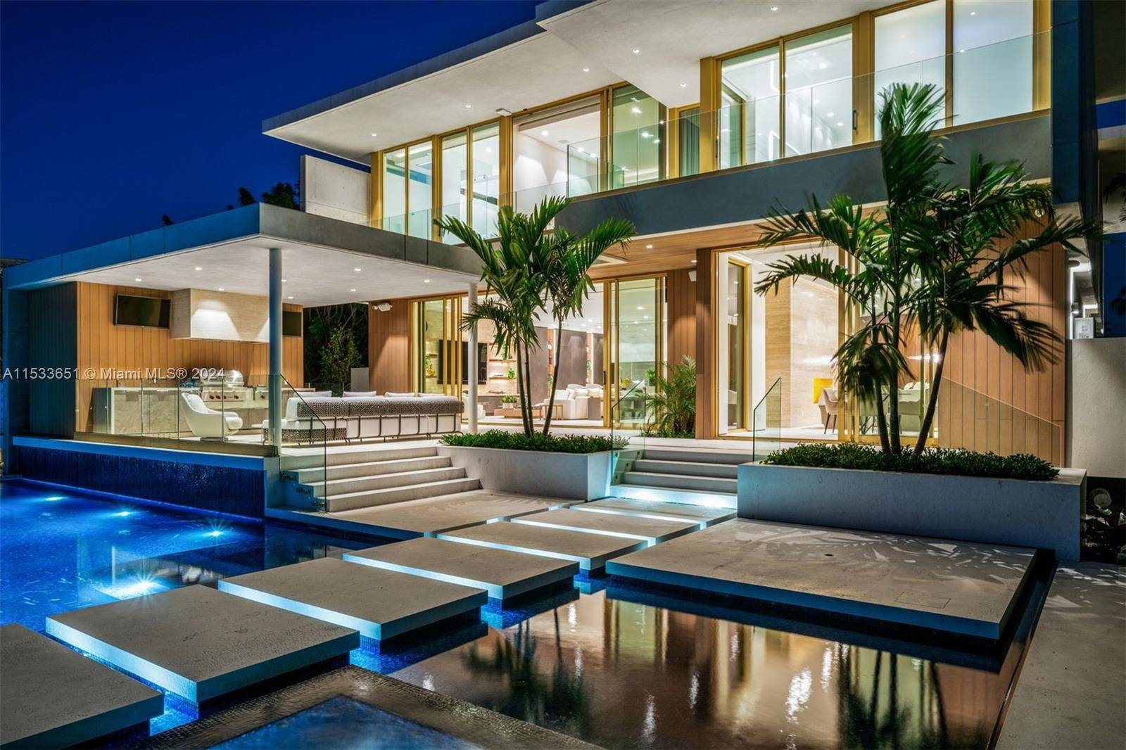 Discover refined living at 6494 Allison Rd, Miami Beach a turnkey gated western waterfront island residence boasting 6 beds and 8.