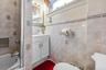 Full bathroom with vanity, tile walls, and tub / shower combination