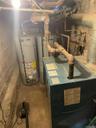 Utility room with water heater and a heating unit