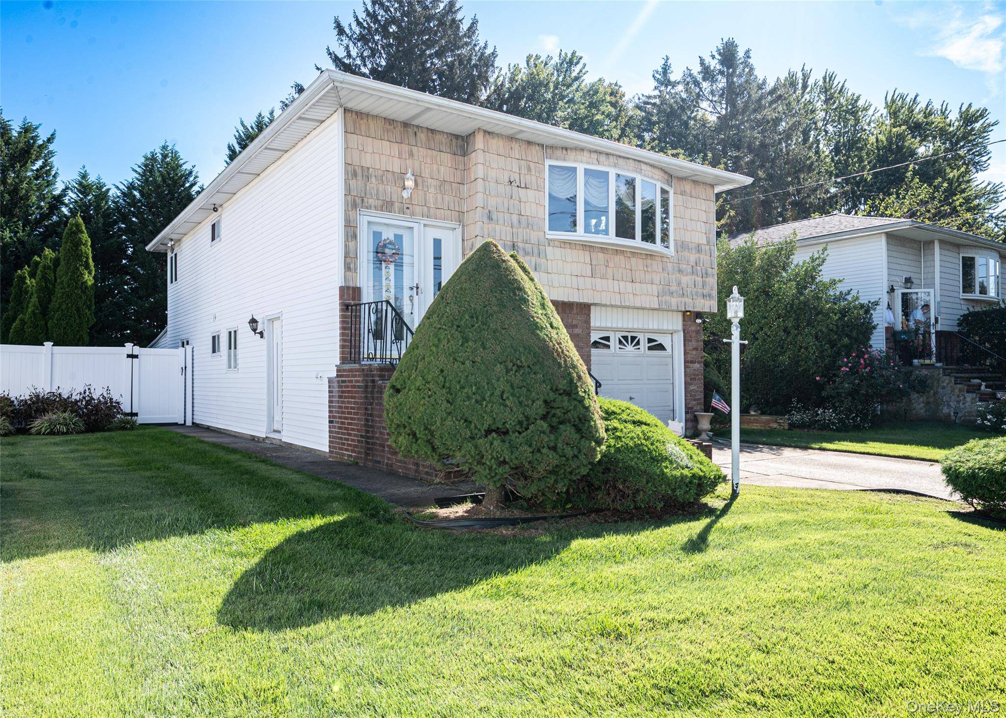 Welcome to 34 Scherer Street, a beautifully maintained Hi Ranch nestled in the heart of Bethpage within the Brenner Estates neighborhood.