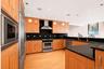 Open Kitchen with stainless steel appliances, hardwood floors and generous cabinetry.