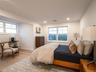 Bedroom featuring multiple windows, hardwood / wood-style flooring, and recessed lighting