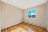 Unfurnished room with a baseboard heating unit, light wood finished floors, and recessed lighting