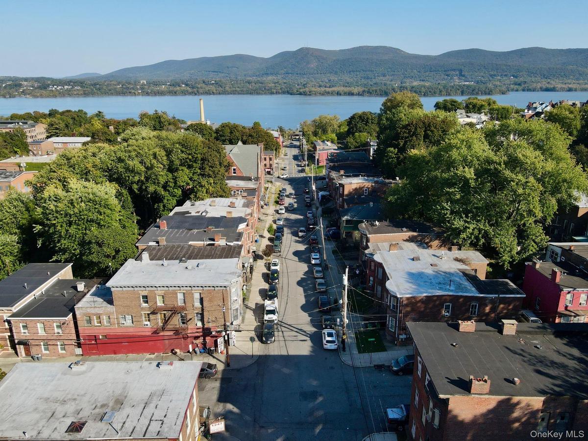 Aerial perspective of suburban area featuring a mountain backdrop