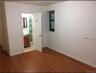Unfurnished bedroom featuring dark wood-style floors and ensuite bath