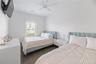 Bedroom featuring dark wood-type flooring and ceiling fan