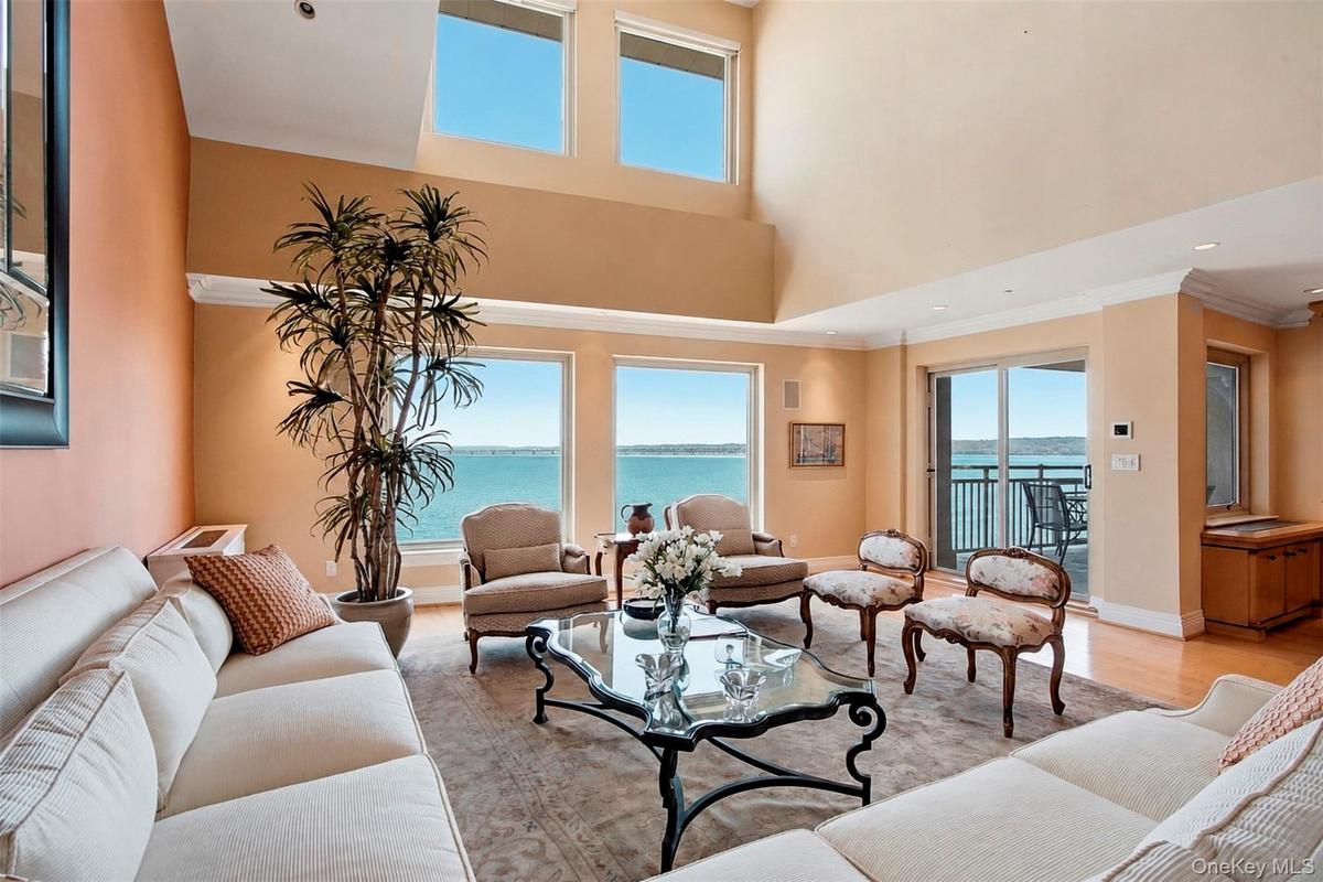Panoramic views of the Hudson River and Mario Cuomo Bridge. Double-height ceilings.