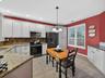 Generous cabinetry and counterspace with a double-window overlooking the professionally landscaped cobblestone walkway.