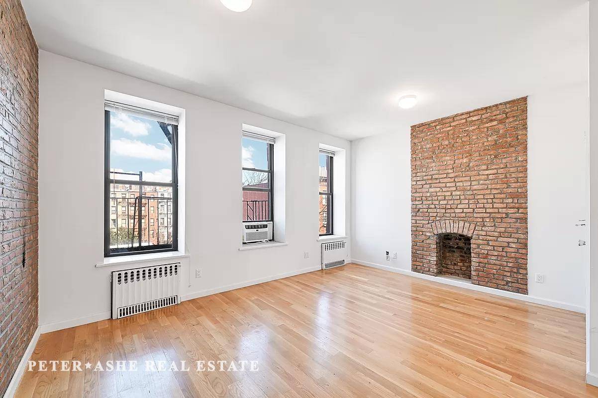 Bright and spacious beautiful exposed brick 2 bedroom 2 bath wall with decorative fireplace.