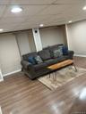 Finished room featuring wood-finish flooring, recessed ceiling lights, and light-toned walls.Apt. #1