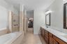 Primary bath with soaking tub, dual vanity, and walk-in shower.