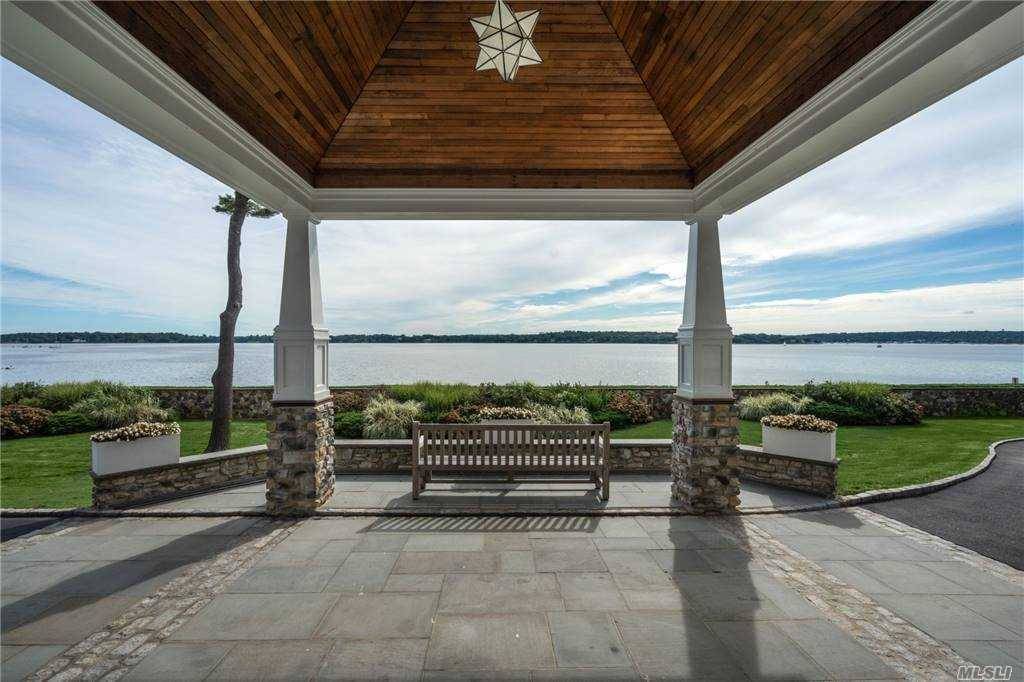 Enter through the custom swing gates and Porte cochere to an exiquite Hampton Style, impeccably maintained home with 180 degrees of breathtaking water views of Oyster Bay's West Harbor.
