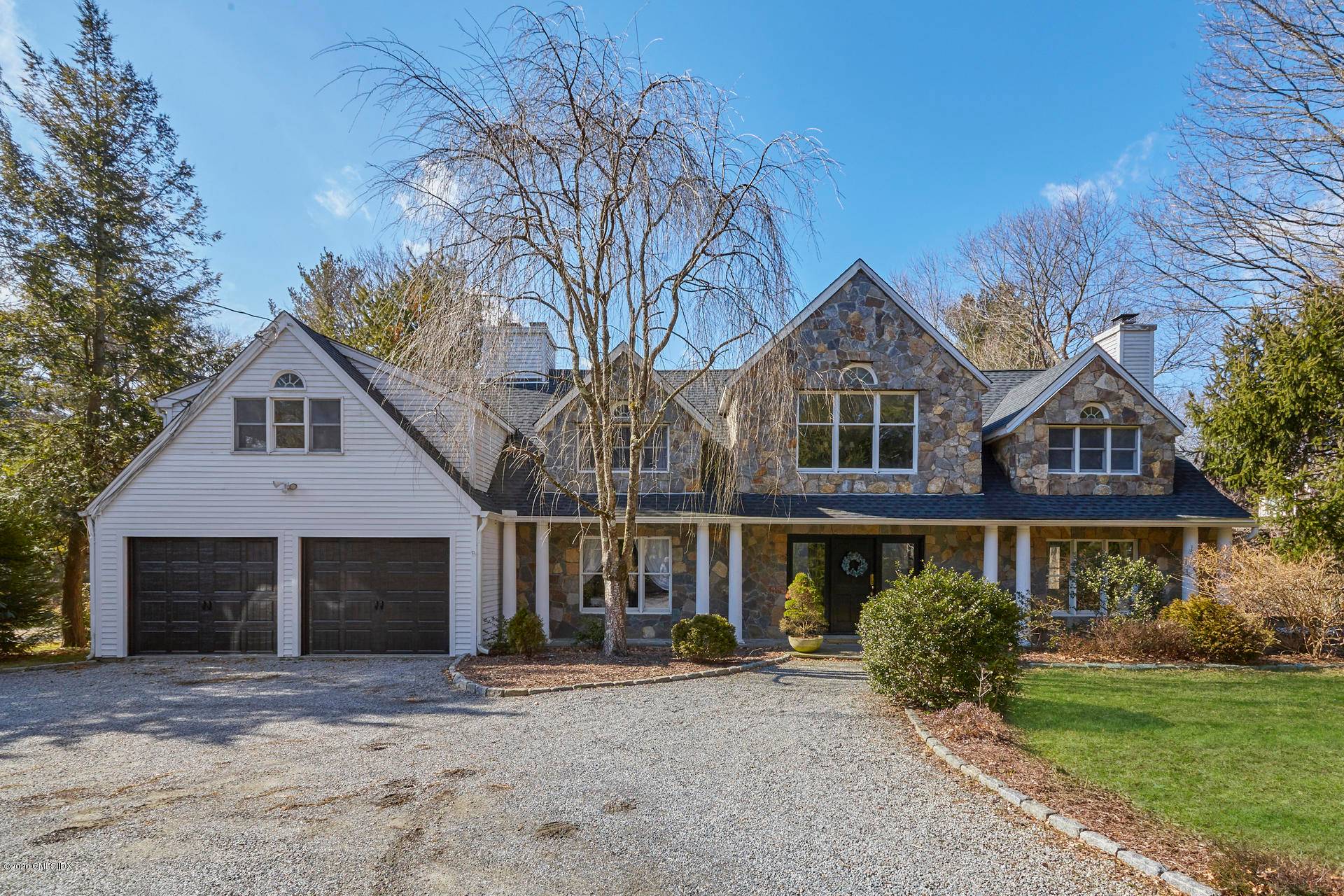 Spacious stone front colonial in coveted Westover perfectly sited on one acre that borders the Mianus River.