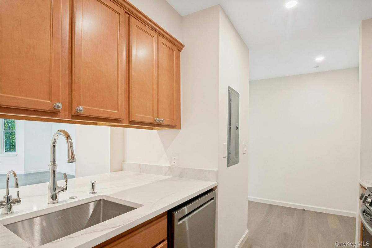 Kitchen featuring new Kohler faucet with pull down spray, sink with hot water dispenser and new dishwasher