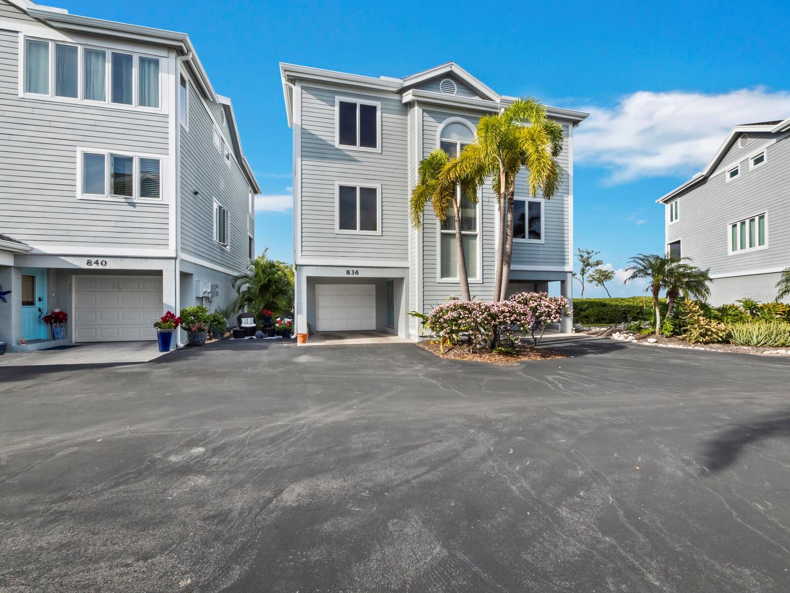 Freestanding home with two deep garages and a private entrance..preserve and Sarasota Bay are on the other side...check out more photos!