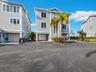 Freestanding home with two deep garages and a private entrance..preserve and Sarasota Bay are on the other side...check out more photos!