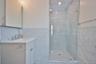 Bathroom featuring tile walls, vanity, a shower stall, and recessed lighting