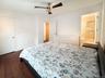 Bedroom featuring dark wood finished floors and ceiling fan