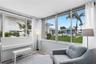 View of sunroom overlooking the courtyard and the heated courtyard swimming pool. Yes, 2 heated pools in the community.