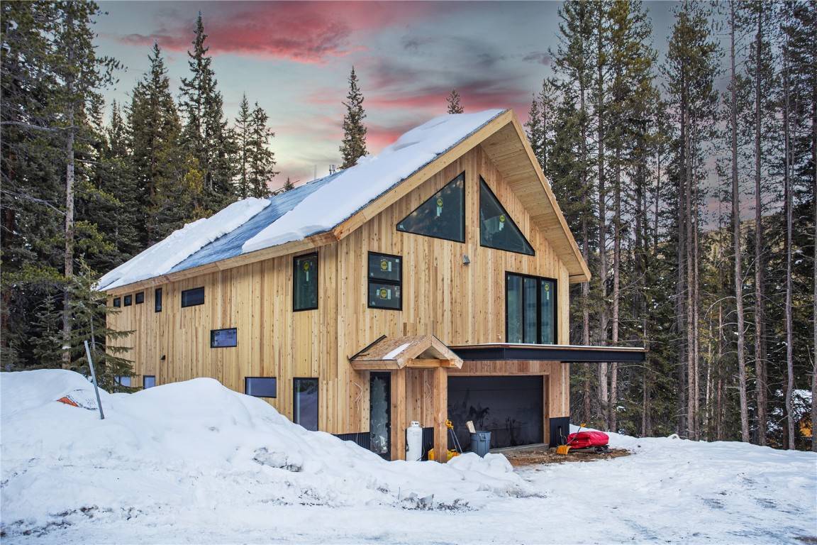 NEW MOUNTAIN CONTEMPORARY CHALET nestled into a forest of towering Spruce trees.