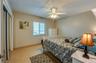 This additional bedroom features soft natural light, a ceiling fan, and ample space, making it ideal for guests or multi-use as a home office or retre