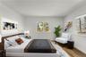 Another view of virtually staged primary bedroom.
