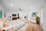 Bedroom featuring ornamental molding, light wood-style floors, recessed lighting, ensuite bath, and a ceiling fan