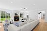 Living area with light wood-type flooring, a large fireplace, and recessed lighting