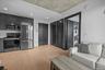 Kitchen featuring stainless steel appliances, light wood-style floors, light countertops, dark cabinets, and recessed lighting