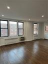 Empty room with hardwood / wood-style flooring, radiator heating unit, recessed lighting, and a wall mounted AC