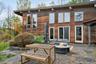 Expansive stone patio backyard overlooking view.