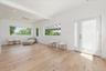 Sitting room with plenty of natural light, light wood finished floors, beamed ceiling, and recessed lighting