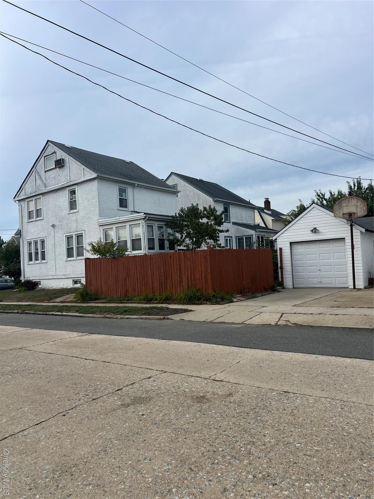 View of home's exterior with a detached garage, an outdoor structure, and driveway