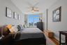 Bedroom 2 featuring a large window with city and tree-lined