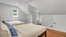 Bedroom with hardwood / wood-style flooring and vaulted ceiling