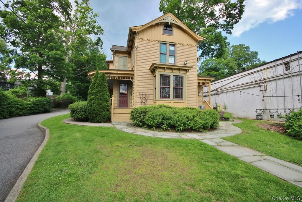 Victorian home featuring a front lawn