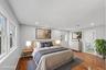 First Floor Primary Bedroom with wood-finish flooring, recessed lighting, and en-suite