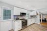 Kitchen featuring appliances with stainless steel finishes, light countertops, light wood finished floors, backsplash, and recessed lighting