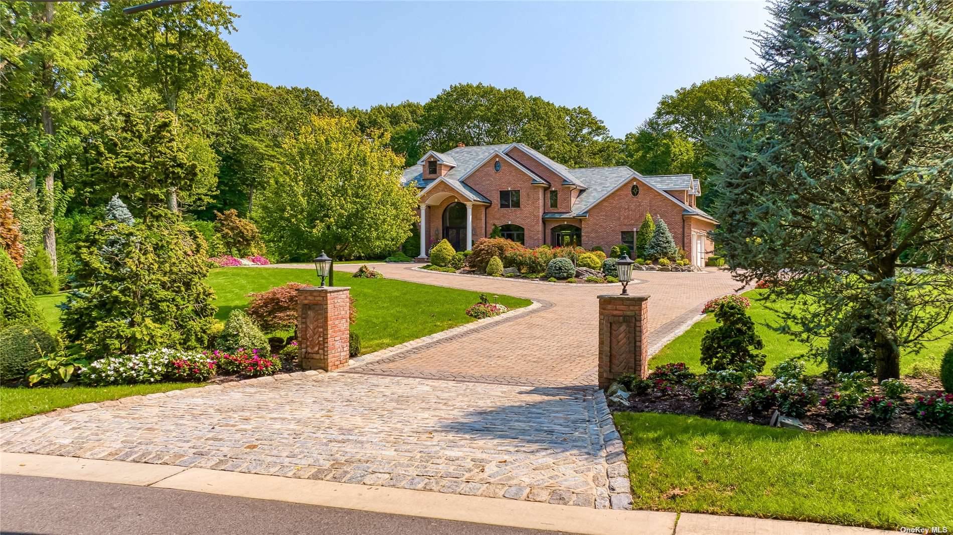 Grand 7091 square foot colonial set on 2 bucolic acres with inground heated salt water pool, waterfall and granite surround.