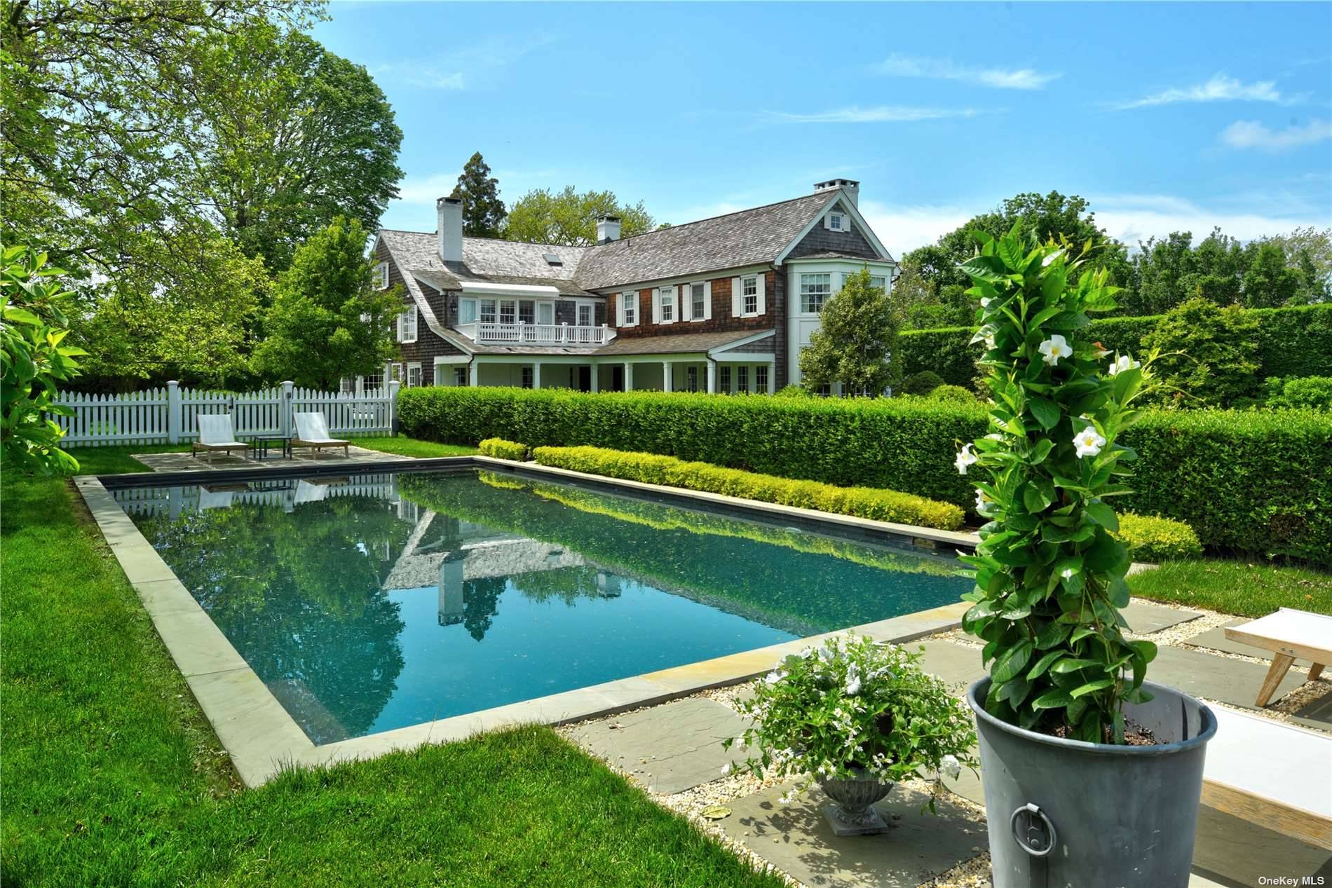 Graceful and refined living in Georgica, South of the Highway in East Hampton, takes place on one and a half acres.