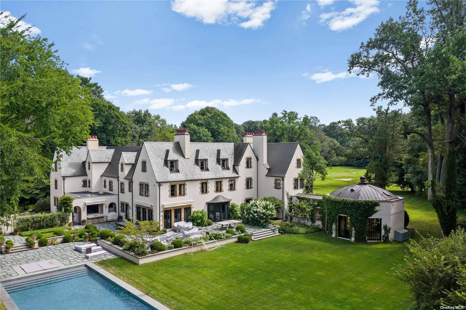 Located in the prestigious Village of Matinecock, this Historic 1926 French Normandy on 6 Prime Acres originally built for J.