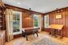 Home office featuring light wood-style flooring, wood walls, and recessed lighting