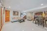 Living room with recessed lighting, light tile patterned flooring, and stairs
