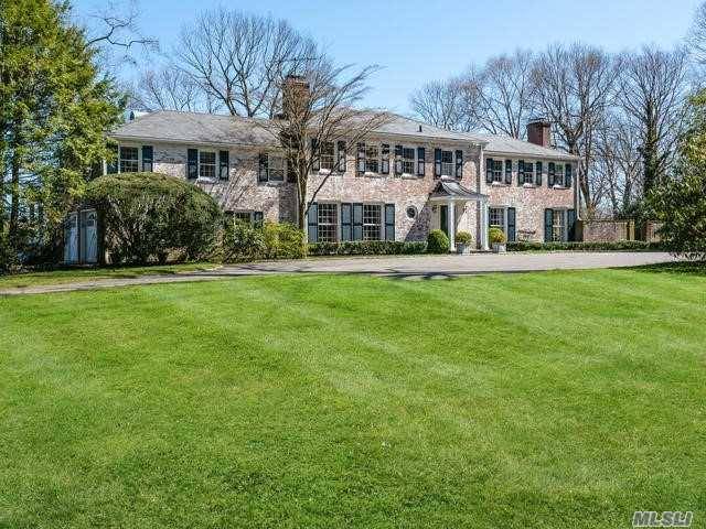 Long Private driveway leads to this 6 bedroom Whitewashed Brick Colonial with Slate Roof, Pool and Tennis court situated on 6 prime Matinecock acres at top of the hill.
