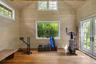 Light-filled wellness studio with vaulted ceilings and French doors opening to the gardens, ideal for yoga, meditation, fitness, or creative pursuits