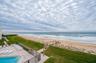 Direct beach access from the building leads to soft sand and surf just steps from your door—coastal living at its finest.