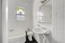 Full bathroom with a garden tub, tile walls, and dark tile patterned floors