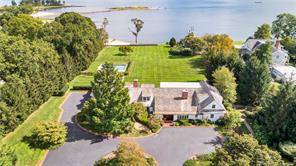 Spectacular 1890 s Nantucket Style Carriage house updated in 2005 on 2 acres with 160 feet of private beach, rolling lawns, mature trees, manicured gardens and heated pool.