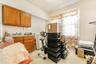 Kitchen with brown cabinets, washer / dryer, and light countertops